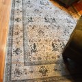 DR01. Wool rug with green, cream and brown. Measures approx. 9' x 6' 
